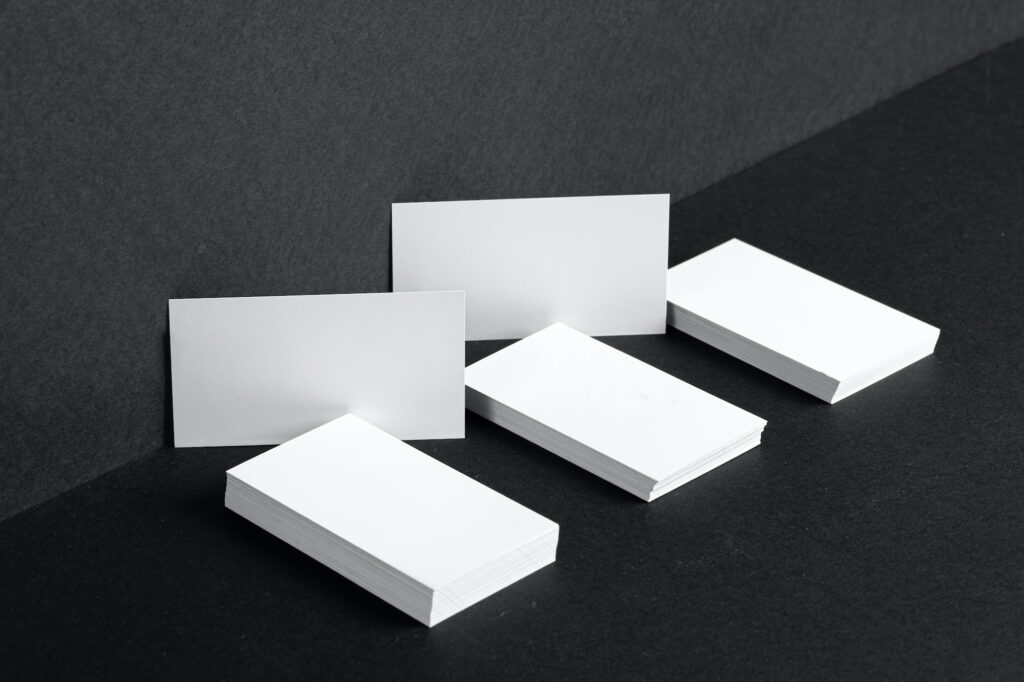 Stacked white businesscards for branding identity on black background